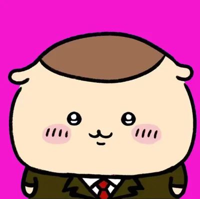 スーツに赤ネクタイ姿のくりまんじゅうピンク背景プロフィール画像