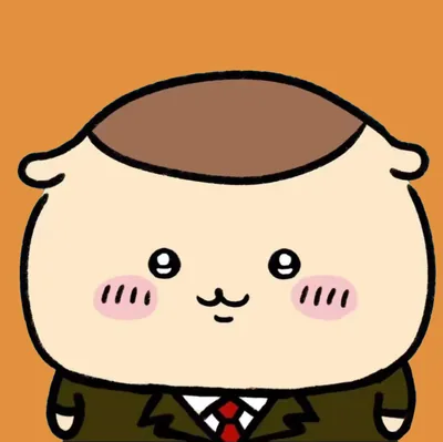 スーツとネクタイを着て微笑むくりまんじゅう SNSアイコン