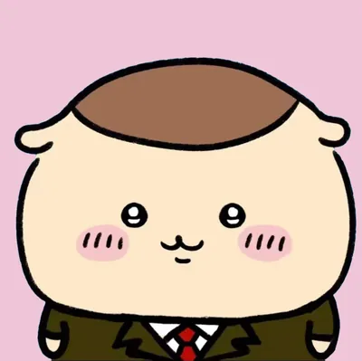 スーツに赤いネクタイ姿でにっこり微笑むくりまんじゅうのプロフィール画像